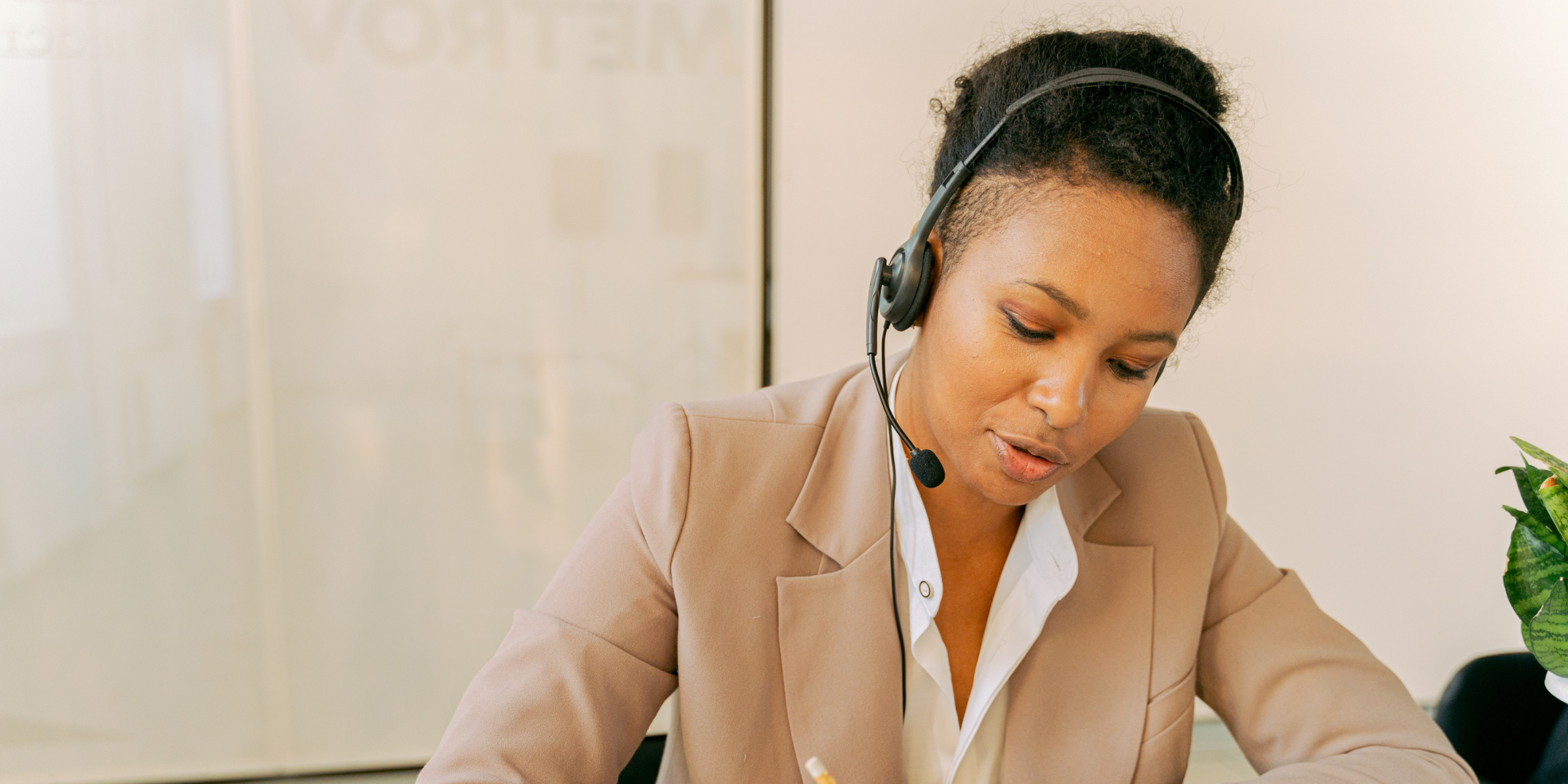 A receptionist triaging patient phone calls from her desktop.