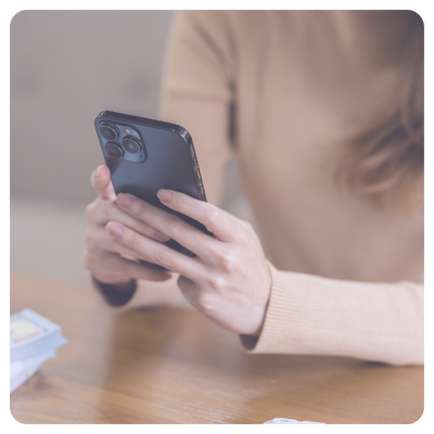 Healthcare staff member using smartphone placing a patient order with another team member