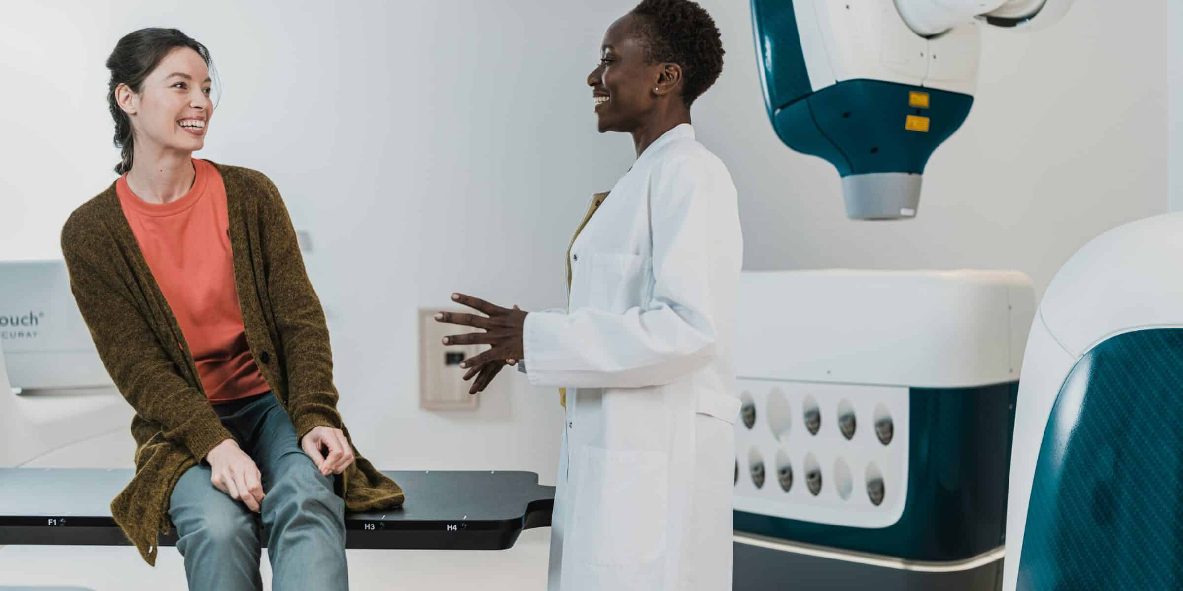 doctor talking to a seated patient